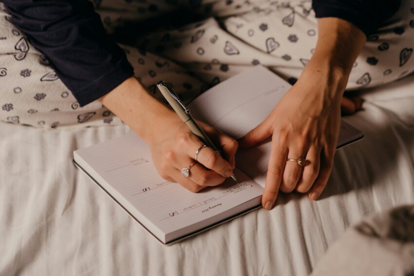 woman writing on note book journaling